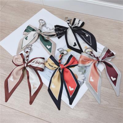 China 2021 Daily Life Hand - Scarf Bow Car Key Chain Horseshoe Woven Silk Women Bag Pendant for sale