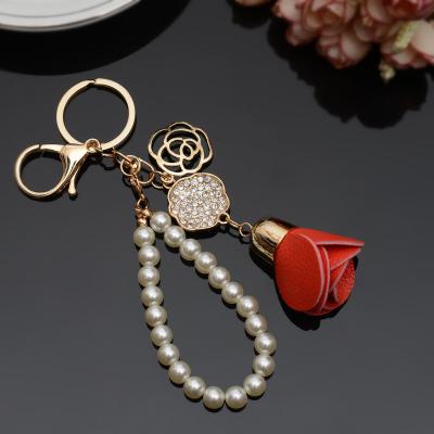 China Korean Leather Car Pendant Bag Pink Camellia Key Chain Rhinestone Tassel Rhinestone Daily Lifestyle Dangling Key Chain for sale