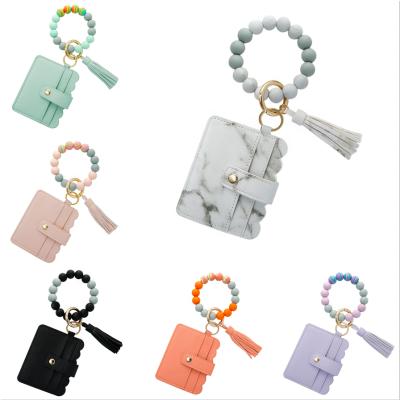 China Silicone Card Bag Bracelet Bangle Fashion Key Chain Fashion Silicone Pearl PU Purse Leather Bracelet For Women Tassel Pendant Key Ring Jewelry Gift for sale