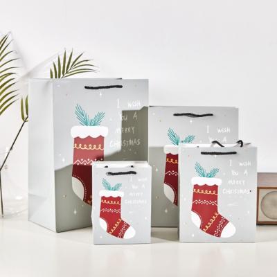 China Merry Christmas Made to Order Recyclable Even Logo Small Paper Bag's Eve Gift Bag Sock 14X15X7 cm for sale