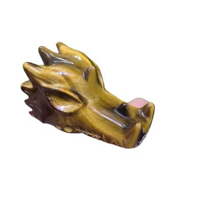 China Europe Natural Hand-carved Skulls Tiger Eye Stone Dragon Head Carving Family Decoration for sale