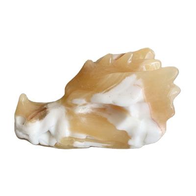 China Europe Natural Orange Calcite Carving Dragon Head Skulls Polished Statue for Home Ornaments for sale