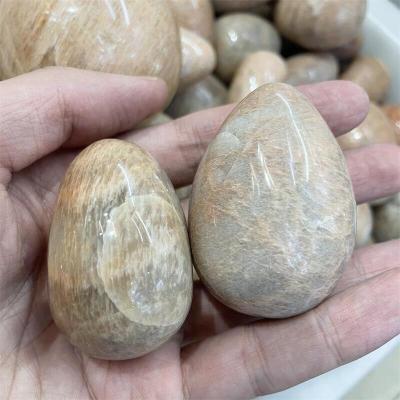 China Wholesale Natural Palm Crystal Carving For Home Decoration Moonstone Eggs From Europe for sale