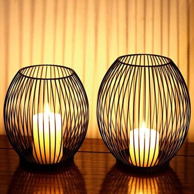 China Modern Art Unique Good Selling Glass Stand Wrought Iron Carved Ornament Lantern Rotate Candlestick for sale