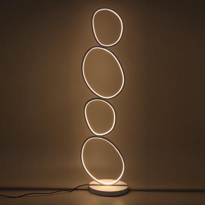 China Modern Creative Minimalist Crossed Rings Round LED Light Position Bedroom Bathroom Circle Aluminum Floor Lamp For Sale for sale