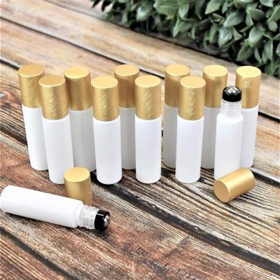 China Perfume / Essential Oil / Lip Oil Unique Custom Gold Roll On White Clear Bottle Roll On Glass Bottle With Gold Cap for sale