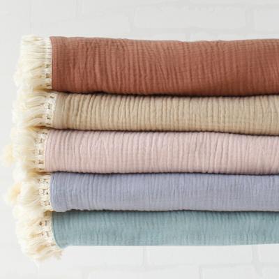 China PORTABLE Wholesale Cotton Muslin Ply Solid Color Newborn Infant Fringe Wrap Bath Towel Baby Wrap Blanket With Tassel Trim for sale