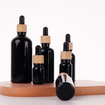 China Custom Logo Luxury Cosmetic Matte Black Serum 100ml Black Screw Cap Essential Oil Glass Bottle for sale