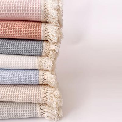 China Anti-static Creative Summer Waffle Solid Color Design Fresh Quilt Fringe Knitted Baby Blanket for sale