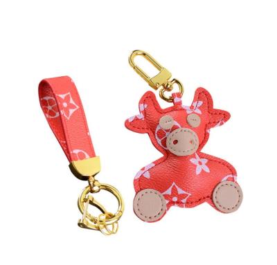 China Eco-friendly fashion cute cartoon leather PU car accessories back pendant key chain for women for sale