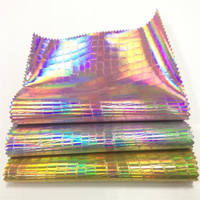 China Waterproof Laser Crocodile Pattern Embossed PU Leather Mirror Reflective Holographic Iridescent Leather Fabric for sale