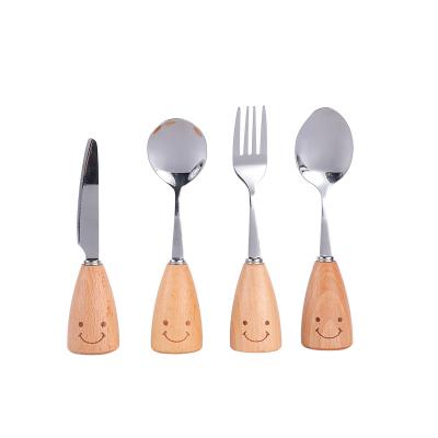 China Viable Creative Smiling Wooden Face Stainless Steel Tableware Handle Children Tableware Stainless Steel Cutlery Spoon Set for sale