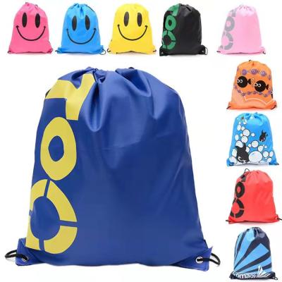 China Fashion Smile Face Drawstring Bag Kids Waterproof Mochila Shopping Bags for Girls and Boys Cartoon Children Backpack Raincoat for sale