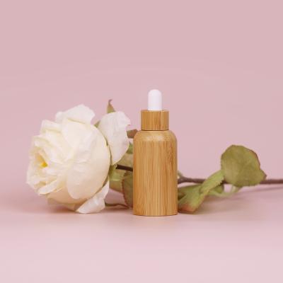 China 50Ml 100Ml 30ml cosmetic bamboo glass bottle, bamboo essential oil dropper bottles for sale