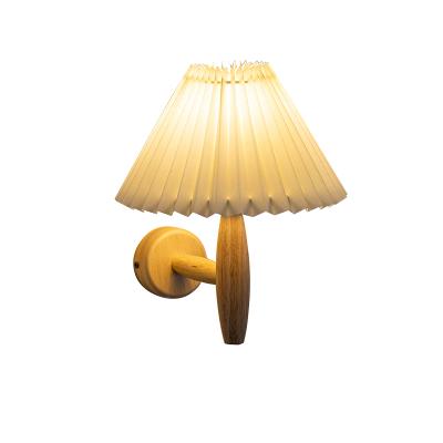 China Versatile modern indoor led wall lamp with pleated lampshade with solid wood bottom and various designs for sale