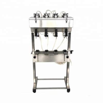 China CLOTHING semi-automatic floral water, toilet water, cologne four fillers vacuum perfume liquid filling machine for sale