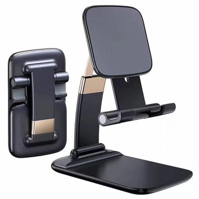 China Flexible Gravity Mini Folding Stand Suitable of New Adjustable Zinc Alloy Foldable Desktop Phone Holder for iPad Mobile Phone for sale