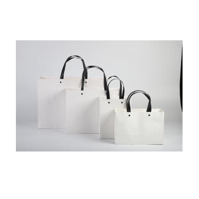 China Handmade Cheap Plain Eco Friendly White Kraft Paper Packaging Bag With Flat Handle for sale