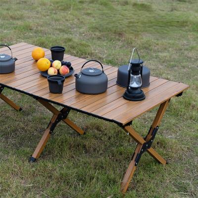 China Large Modern High Quality Portable Folding Metal Self Driving Outdoor Wooden Grain Camping Aluminum Alloy Egg Roll Table With Carry Bag for sale