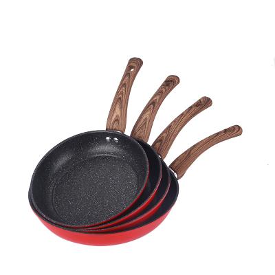 China Household cookware wholesale high quality non stick frying pan with bottom stainless steel handle kitchen red wooden frying pan for sale