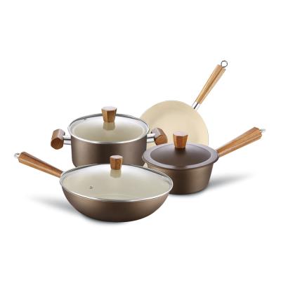 China Sustainable press type kitchen carbon steel cookware set with non stick white ceramic coating and wooden handles for sale