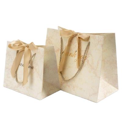 China New Pattern Recycled Materials Yellow Marble Thank You Printed Gift Bag With Ribbon White Panel Custom Cheap Apparel Paper Bag for sale