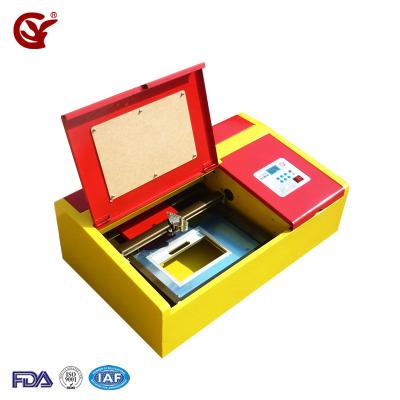 China Laser Engraving Mini 3020 Laser Cutting Machine Polymer Rubber Stamp Machine Mini Seal 3020 Laser Engraving Rubber Stamp Machine Price for sale