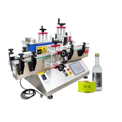 China Food cheap automatic desktop adhesive sticker labeling machine for oil bottle round glass cans for sale