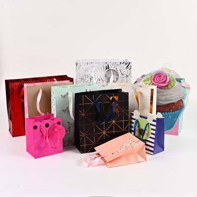 China Recyclable Fancy Cartoon White Kraft Paper Bag With Bowknot Decoration Paper Gift Bags New Small Special PVC Hook And Tag Shop Bags for sale