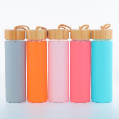 China Cheap Sustainable Hot Selling Excellent Quality Custom Logo Kids Glass Waterbottles With Bamboo Lid for sale