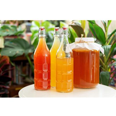 China 500ml 750ml 1l Clear Top Cap Swing Beer Bottle Kombucha Bottle Stocked Glass Water Bottle for sale