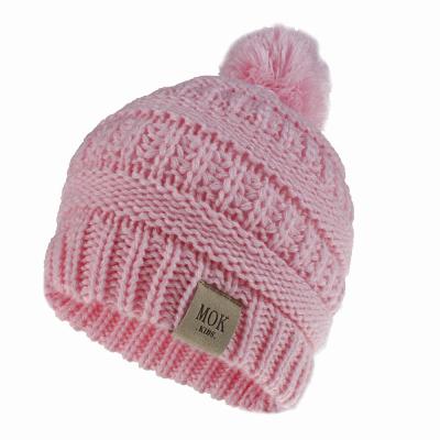 China 2020 COMMON Hot Selling Acrylic Knit Wholesale Custom Winter Kids Beanie Hats Winter Hats With Pom Poms for sale