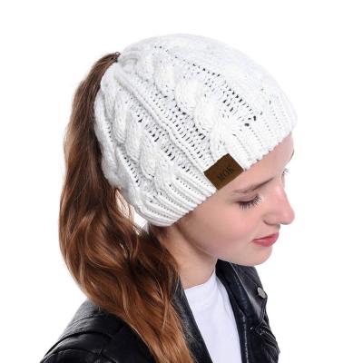 China 2020 Hot Sale Wholesale Custom Acrylic Knitted Winter Ponytail Hats Women Winter Ladies Beanie Hats COMMON With Hole for sale