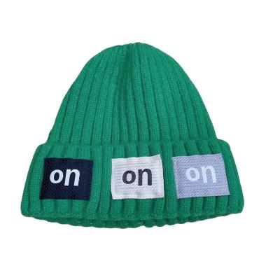 China COMMON 100% Acrylic Custom Adults Plain Ribbed Style Winter Toques Knitted Label Woven Beanie Hat for sale