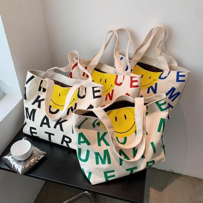 China 2021 Bulk High Quality New Fashion Canvas Bags Casual Girls Tote Shoulder Bag High Capacity Women's CIA Luxury Cartoon Letter Smile Face Bag for sale