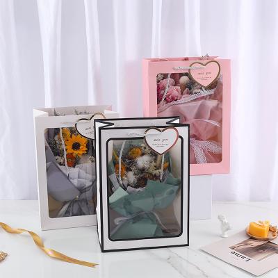 China Wholesale Recyclable Creative Clear Window Flower Paper Bag Carrier Gift Packaging Clear Paper Bag for sale