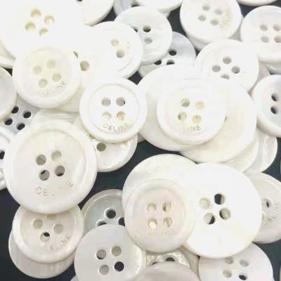 China Viable Button With Logo Shell Button Black Shell White Shell Laser Logo 17.8mm Diameter 28L Good Quality for sale