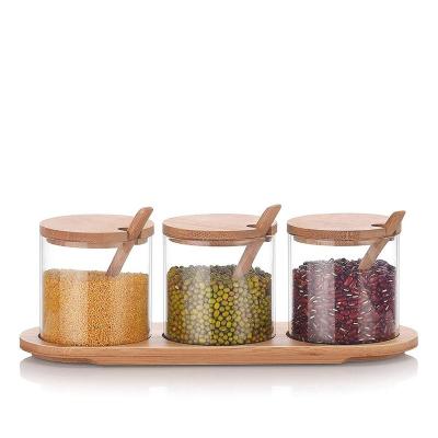 China Viable hot seller condiment container seasoning box set condiment canisters glass jars with lid and bamboo spoon base for sale