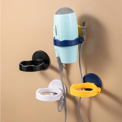 China Wall Mounted Hair Dryer Storage Rack Multifunctional Viable Fan Stand Punch Free Bathroom Hair Dryer for sale