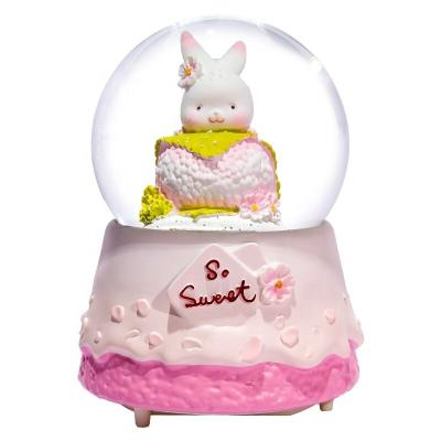 China YIWU BAIWEN Folk Art Manufacture Wholesale Promotion Rabbit Macaron Snow Globe Music Box For Girlfriend Gift for sale