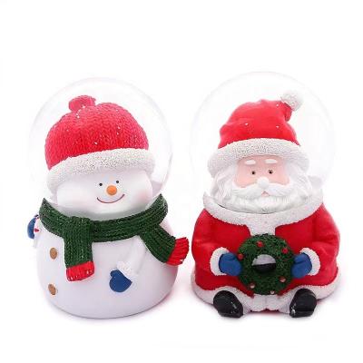 China New Folk Art 2022 Promotional Christmas Glass Resin Inflatable Snow Globe With Christmas Santa 45mm Snow Globe for sale