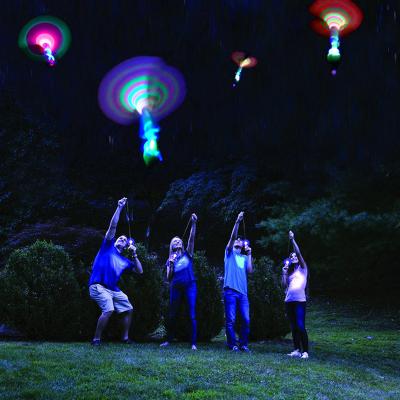 China Plastic Parachute Sky Flying Shooting UFO Bamboo Dragonfly With Light Night Party Outdoor Toy For Kid Children for sale