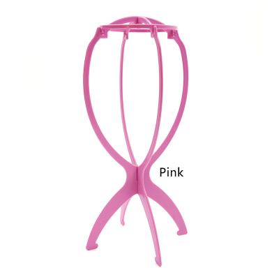 China Wig Hair Bulk Wig Stands Factories Portable Durable Plastic Folding Wig Stand Pink Wig Hair Rack for sale