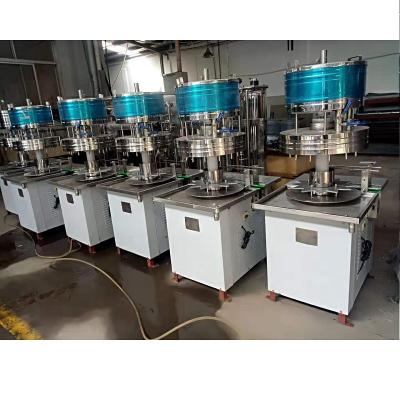 China Rotary Beverage Manual Gravity Liquid Filling Machine With Automatic Capping Machine Low Cost High Efficiency for sale