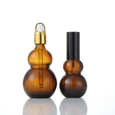 China Personal Care 10ml-100ml Amber Glass Essential Oil Double Bottle Gourd Shape Dropper Bottle 30ml for sale