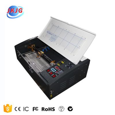 China Laser REDUCING CO2 JK3020 Acrylic Sheet Cardboard Apparel Laser Cutting Machine Price for sale