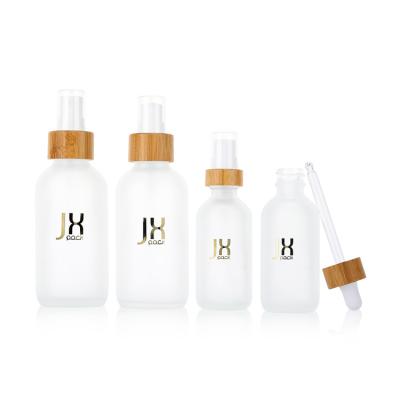 China 60ml 120ml 250ml cosmetic frosted white glass bottles with eco-friendly bamboo lid dropper glass dropper bottle for sale