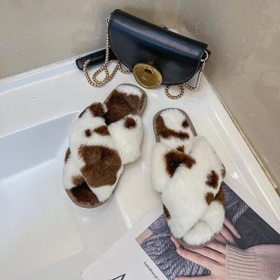 China Fashion Trend OEM Cow Print Fuzzy Cross Over Fleece Faux Fur Bedroom Winter Slipper for sale