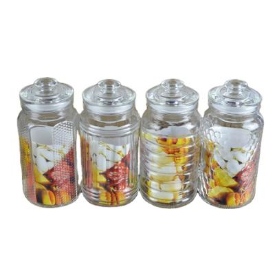 China Food Kitchenware Daily Use Storage Container For Peanut Clear Glassware Engrave Patterns 800ml Storage Glass Jar With Lid 4 Designs for sale