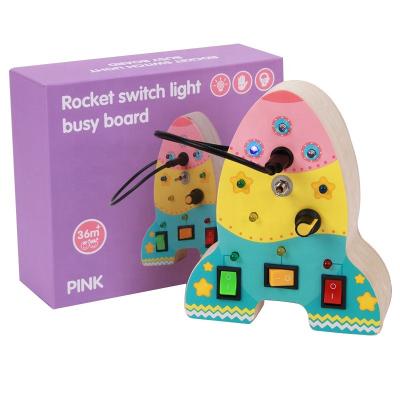 China Kids Learing Toys Kids Wooden Sensory Toys Rocket Shaped Busy Board with Bright LED for sale